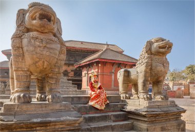 Dunbar Square, Bhaktapur, Nepal - February 10th 2025 - A child dressed traditionally sat in Dunbar Square being the Living Goddess Kumani  clipart