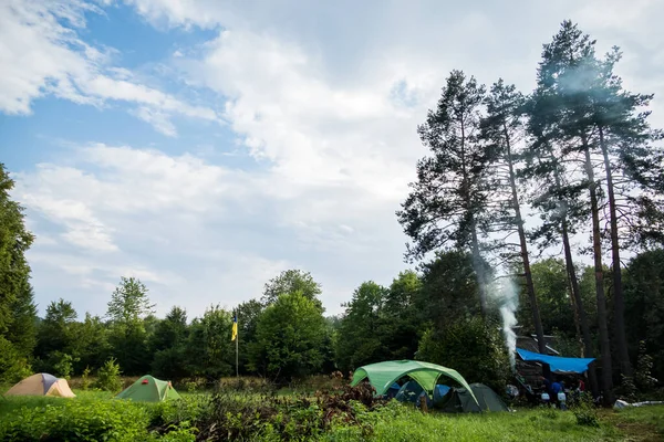 stock image camping in the mountains with tents, log house, tourism