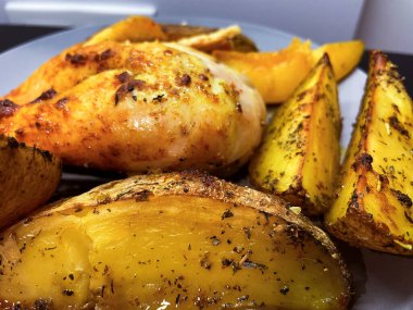 Gri tabakta fırında patates ve köri soslu tavuk. Yüksek kalite fotoğraf