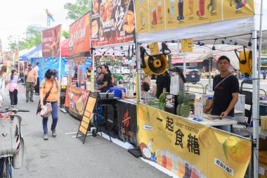 Toronto, ON, Canada - August 17, 2024: Chinatown festival food vendors present they product on Spadina Avenue at the Toronto Chinatown Festival 2024. clipart