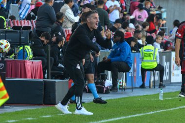 Toronto, ON, Canada - October 5, 2024: Head Coach of the Toronto FC John Herdman gives instructions to players during the 2024 MLS Regular season match between Toronto FC (Canada) v Inter Miami CF (USA) at BMO Field. clipart