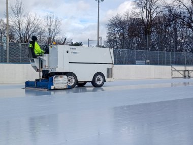 Toronto, ON, Canada - January 10, 2025: Zamboni ice cleaning machine is cleaning ice rink in the park clipart