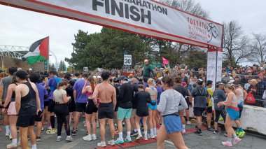 Toronto, ON, Kanada - 29 Nisan 2025: Toronto Maratonu bitiş çizgisinde büyük bir koşucu grubu toplanıyor. Çok sayıda koşucu ve dar yol geçişi imkansız kılıyor..