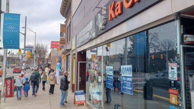 Toronto, ON, Kanada - 14 Nisan 2025: İnsanlar Durie Caddesi yakınlarındaki Bloor Caddesi boyunca 9 bahar öğleden sonra bulutlu bir gökyüzü altında yürüyüp alışveriş yapıyorlar.