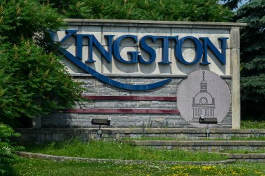Kingston, ON, Canada - September 18, 2025: A welcome sign for the city of Kingston is visible from a highway on a cloudy day.