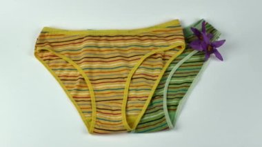 A pair of cotton panties for a girl in cheerful colors. Underwear for teenagers. The concept of beautiful and comfortable underwear for girls and women.