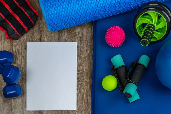 Fitness accessories. Close-up of dumbbells for arms and legs, weights for legs, balls for acupuncture points on body, wheel for training the press and back, a roller for fitness and yoga. Copy space
