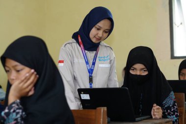 Editorial. Bawang, Jawa Tengah, Indonesia - October 19 2022. Indonesian elementary school students study online using chrome laptops