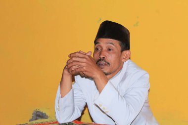 Bawang, Jawa Tengah, Indonesia - October 19 2022. A religious teacher alone waiting for his students