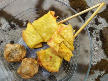 Pangsit goreng ( Fried dumplings ) and fried meatballs, street food of Indonesia