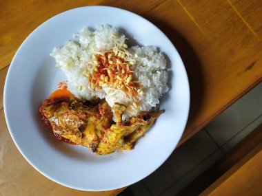 Grilled chicken with chili sauce in the white plate