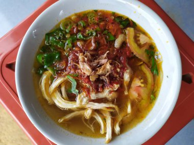 Mie Ayam ( chicken noodles ), street food of Indonesia against a background of blur and bokeh, selective focus
