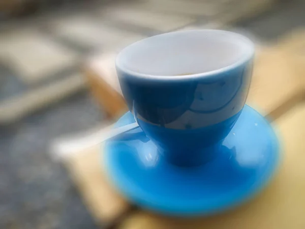 Blury blue mug on a wooden table