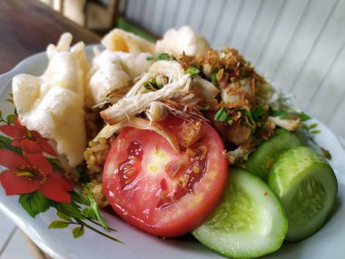 Nasi Goreng ( fried rice ) is an Indonesian food, made from white rice then fried with soy sauce and vegetables