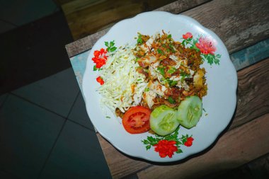 Nasi Goreng ( fried rice ) is an Indonesian food, made from white rice then fried with soy sauce and vegetables