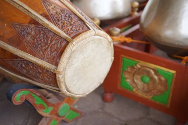 Gamelan müziğinde ritmi sağlamak için kullanılan süslü, kırmızımsı kahverengi ahşap oymalı bir vücudun yer aldığı geleneksel bir Java Kendang davulunun ayrıntılı bir yakın çekimi. Endonezya kültür mirası konsepti