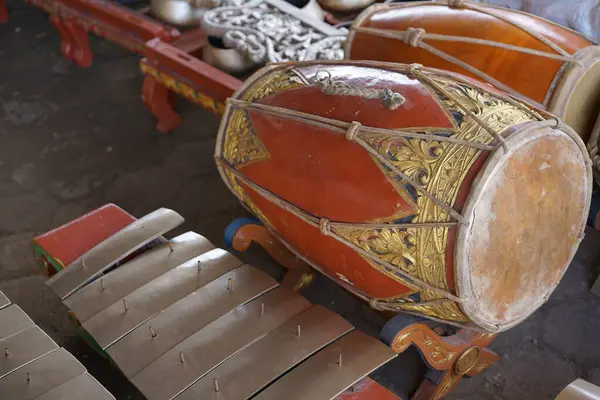 Gamelan müziğinde ritmi sağlamak için kullanılan süslü, kırmızımsı kahverengi ahşap oymalı bir vücudun yer aldığı geleneksel bir Java Kendang davulunun ayrıntılı bir yakın çekimi. Endonezya kültür mirası konsepti