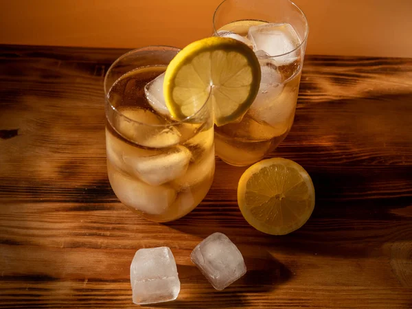 Iced tea in a glass with ice cubes. Cold tea with ice. Close up.