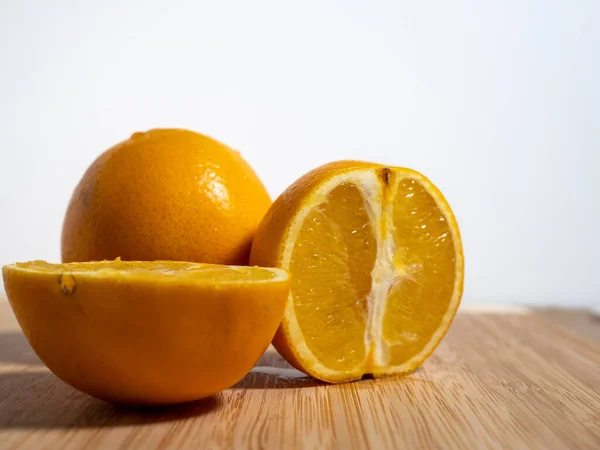 Ripe orange fruit on a white background. Close-up.