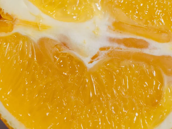 Juicy slice of orange. Texture of orange pulp. Close-up.