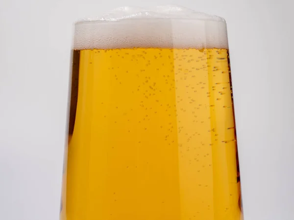 Glass of beer on a white background. A glass of light beer with foam. close-up.
