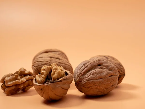 stock image Walnut on an orange background. Raw walnut. Close-up.