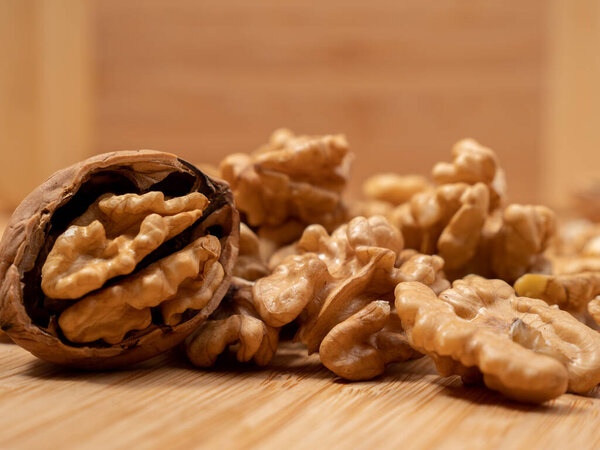 Walnut on a wooden background. Raw walnut. Close-up.