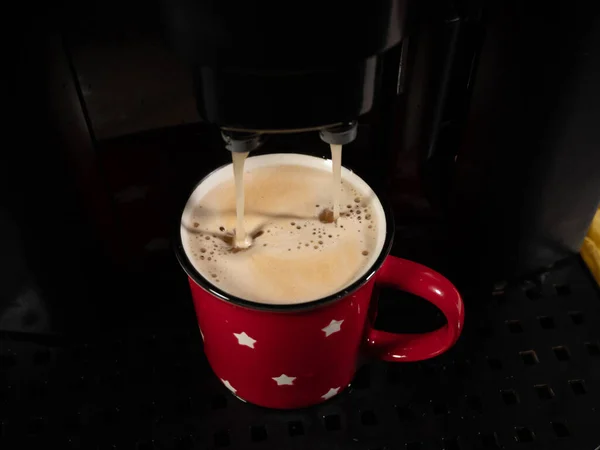 The coffee machine fills the cup. Preparing coffee with a coffee machine. Breakfast drink.