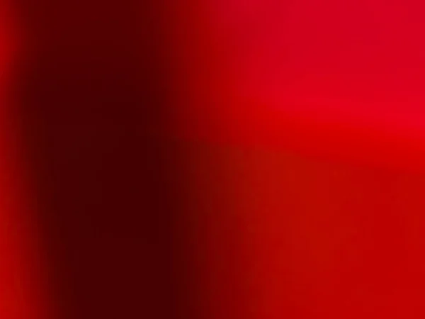 Red background. Red wall with shadow. Abstract background. close-up.