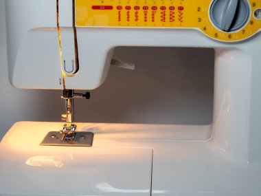 Electric sewing machine on a white background. Close-up.