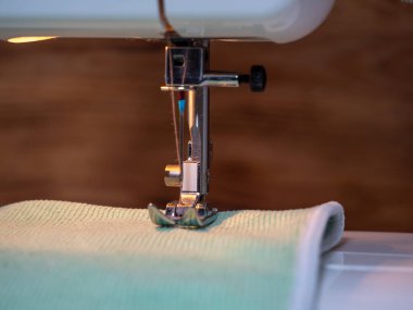 Electric sewing machine on a wooden background. Close-up.