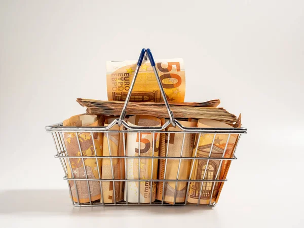 Shopping cart full of money. A shopping cart filled with euro banknotes. Shopping basket with money on a white background.