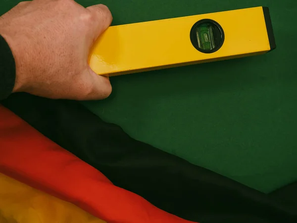 German flag and work tool on green. Concept Made in Germany. German quality.