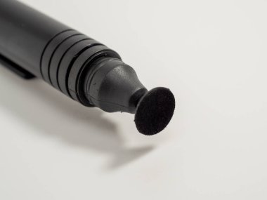 Brush for cleaning the lens on a white background. Close-up.