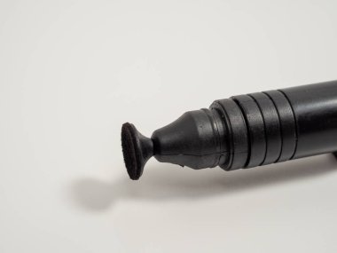 Brush for cleaning the lens on a white background. Close-up.