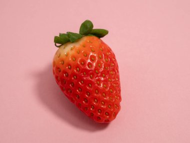 Ripe strawberries on a pink background. Strawberries close up. Red strawberry.