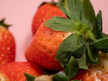 Ripe strawberries on a pink background. Strawberries close up. Red strawberry.