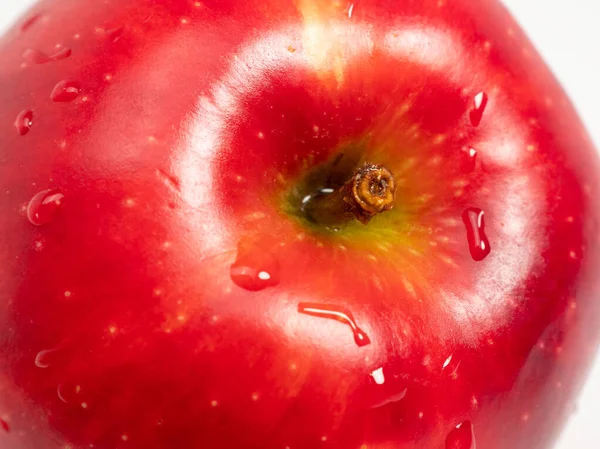 Red apple on a white background. Juicy apple. Close-up.