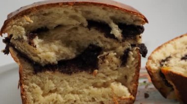 Freshly baked bread with poppy seeds rotates on a white background. Bread with poppy seeds close-up.
