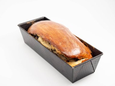 Freshly baked bread with poppy seeds in a mold. Close-up.