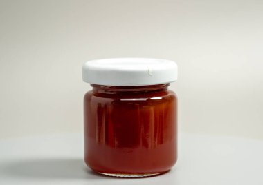 A jar of apple jam. Homemade apple jam on a gray background. Close-up.