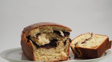 Freshly baked bread with poppy seeds rotates on a white background. Bread with poppy seeds close-up.