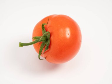 Red tomato on a white background. Fresh tomato. Close-up.