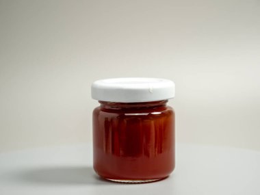 A jar of apple jam. Homemade apple jam on a gray background. Close-up.