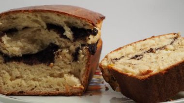 Freshly baked bread with poppy seeds rotates on a white background. Bread with poppy seeds close-up.