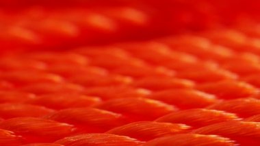 Orange rope close-up. Texture of braided rope. Orange background.
