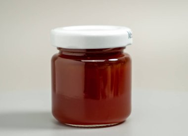 A jar of apple jam. Homemade apple jam on a gray background. Close-up.