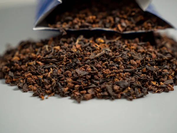 Black tea. Dry brewing of black tea. Black tea packaging.