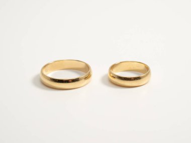 Wedding rings on a light background. Gold rings. Close-up.