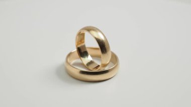 Wedding rings on a white background. Gold rings. Close-up.
